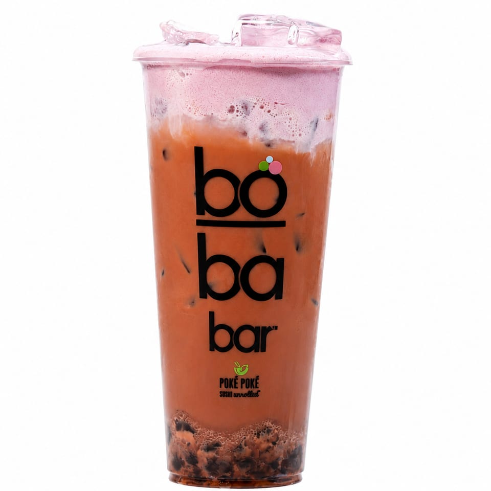Boba Bar's Thai Iced Tea with a pink foam topping and tapioca pearls, in a clear plastic cup.