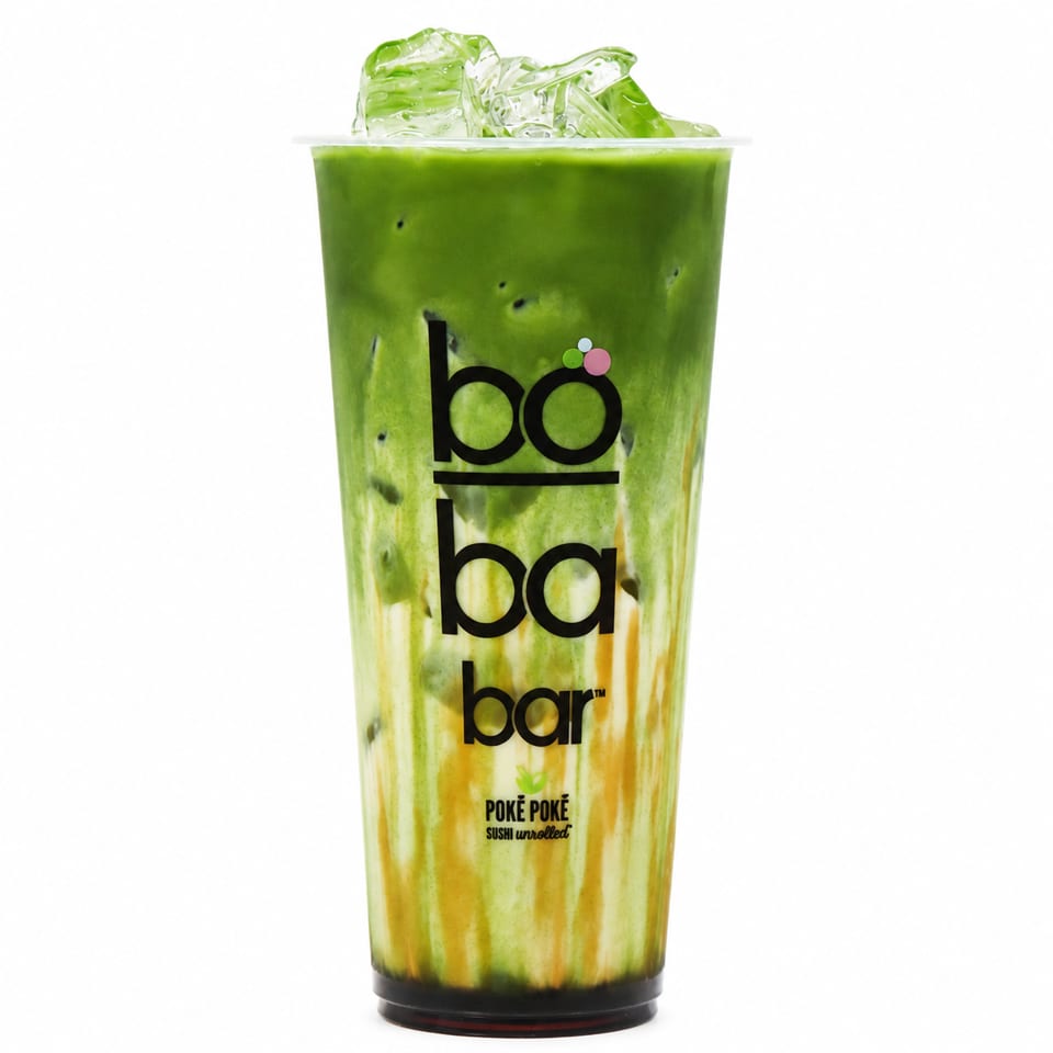 Iced green matcha boba tea with caramel swirls in a clear plastic cup.