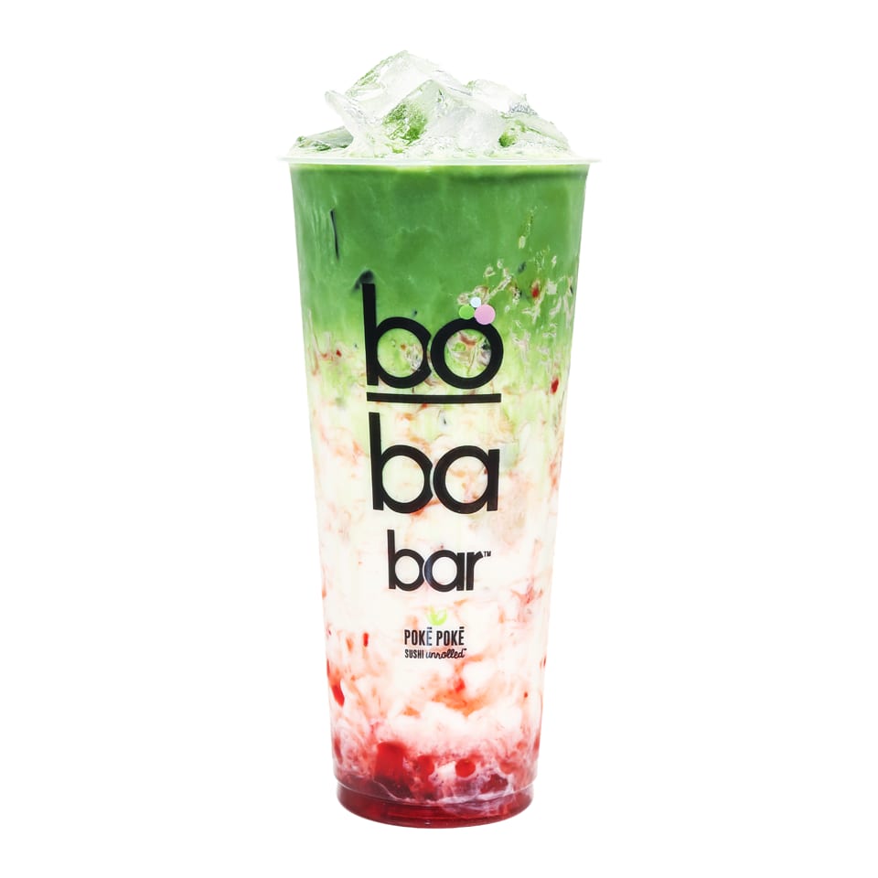 A Boba Bar drink with layers of green matcha, white milk, and red strawberry, topped with ice.