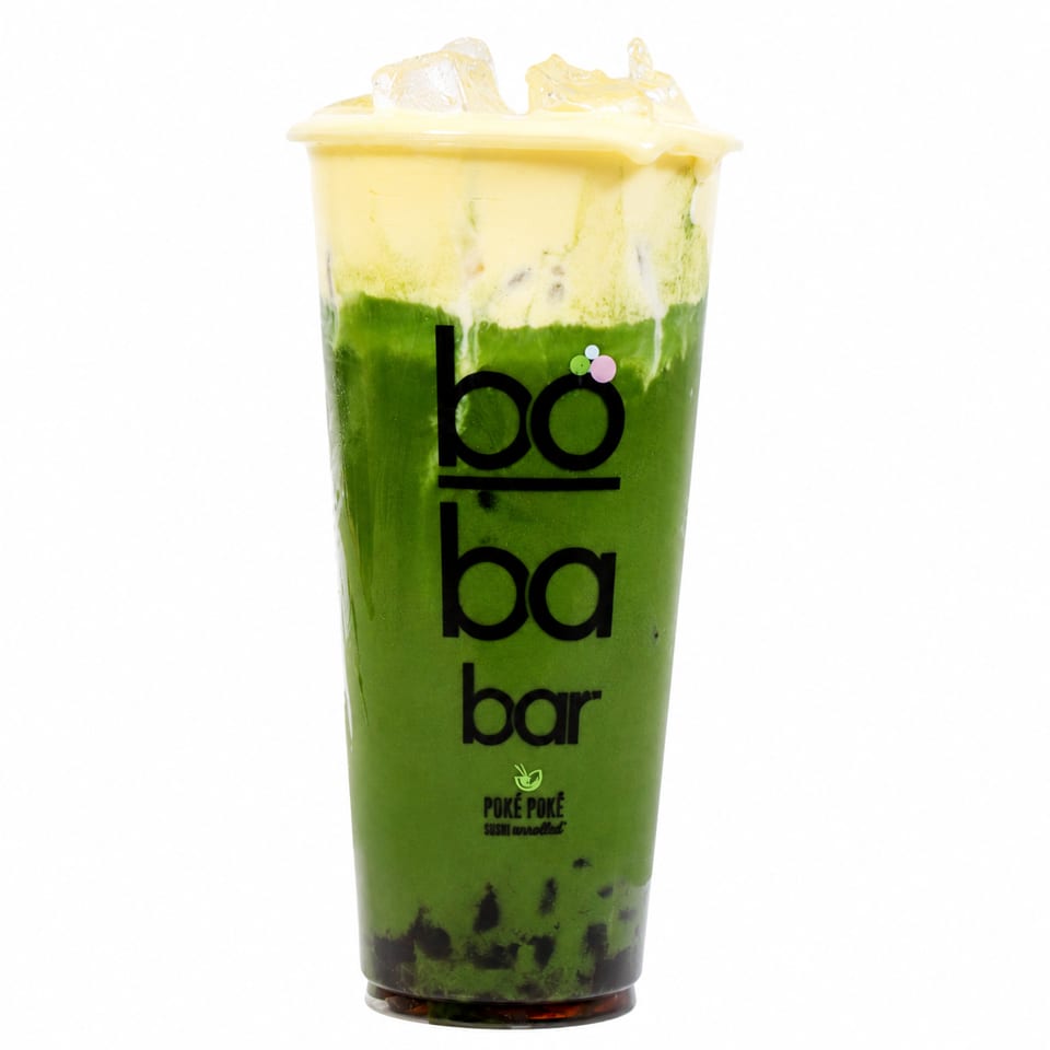 Boba Bar's green matcha drink with a creamy yellow topping and ice, on a white background.