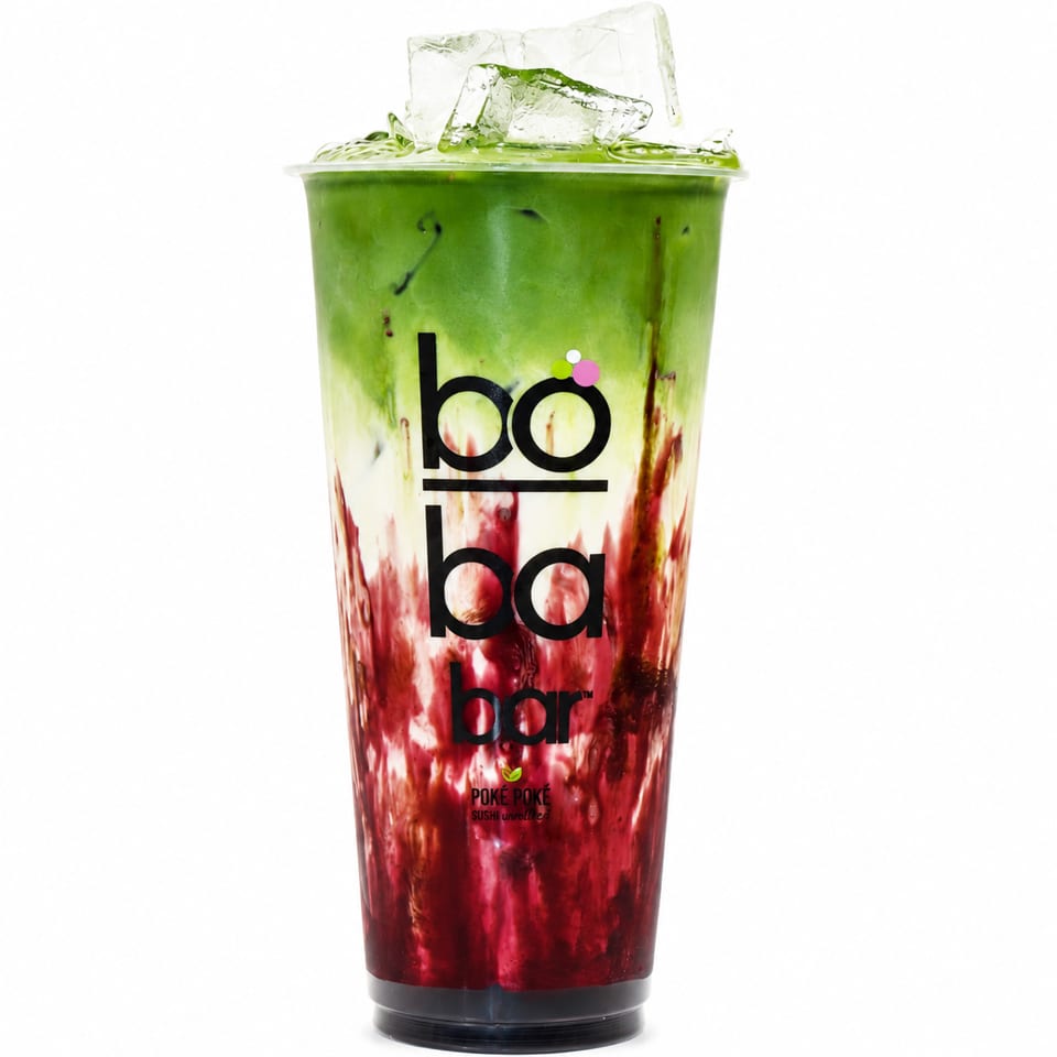 Iced Boba Bar drink with green matcha, white milk, and red fruit syrup layers.